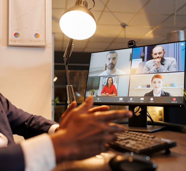 entrepreneur-discussing-financial-statistics-with-remote-team-online-videocall-meeting-conference-diverse-corporate-employees-working-overhours-company-growth-report-startup-office (1)